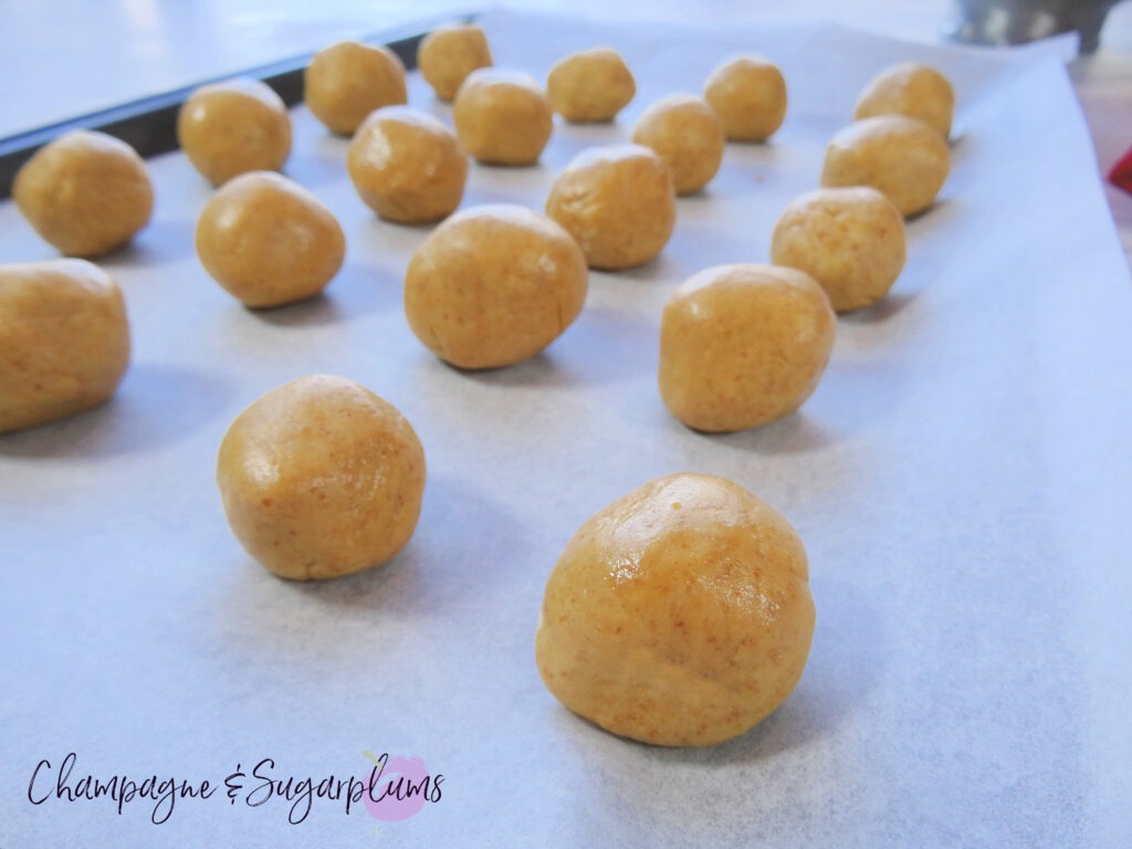 Snowball treats on a baking tray by Champagne and Sugarplums 