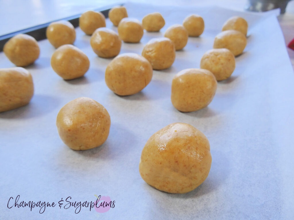 Snowball treats on a baking tray by Champagne and Sugarplums