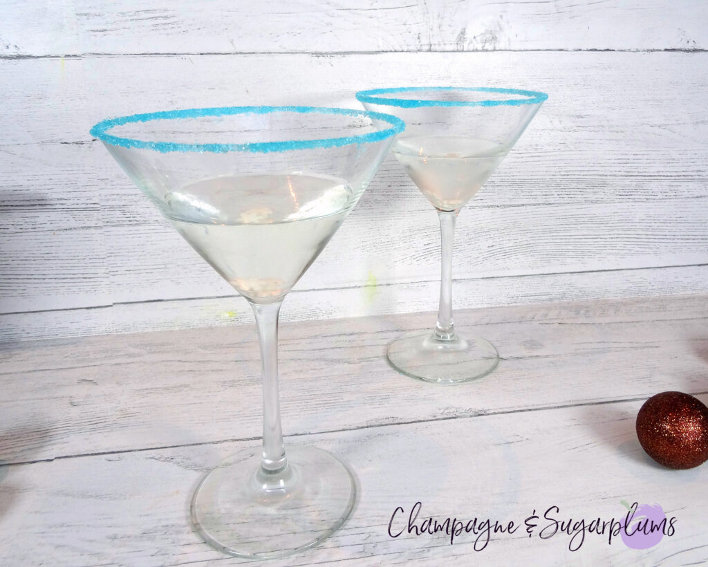 Polar Bear Martini cocktails, rimmed with blue sugar on a white background by Champagne and Sugarplums