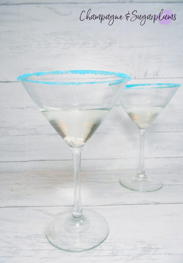 Polar Bear Martini cocktails, rimmed with blue sugar on a white background by Champagne and Sugarplums