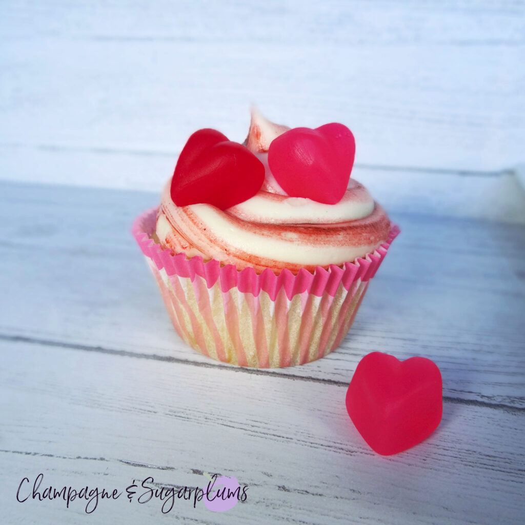 A Cherry Cupcake on a white background with a pink candy heart by Champagne and Sugarplums