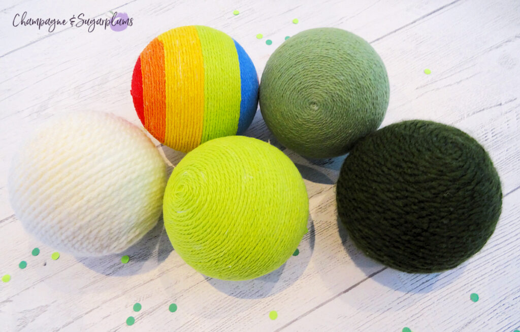 Lucky Green Balls - Styrofoam balls wrapped in varying shades of green on a white background by Champagne and Sugarplums