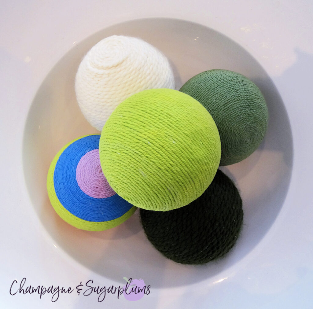 Lucky Green Balls - Styrofoam balls wrapped in varying shades of green in a white bowl by Champagne and Sugarplums