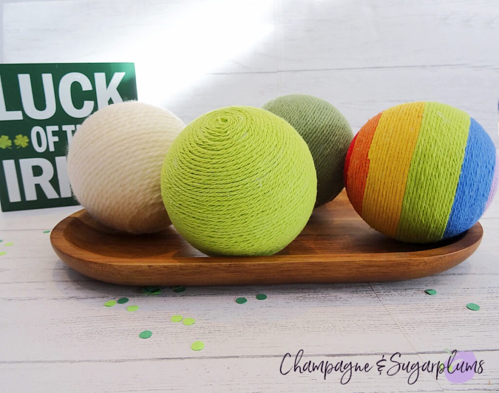 Lucky Green Balls - Styrofoam balls wrapped in varying shades of green in a wood tray by Champagne and Sugarplums