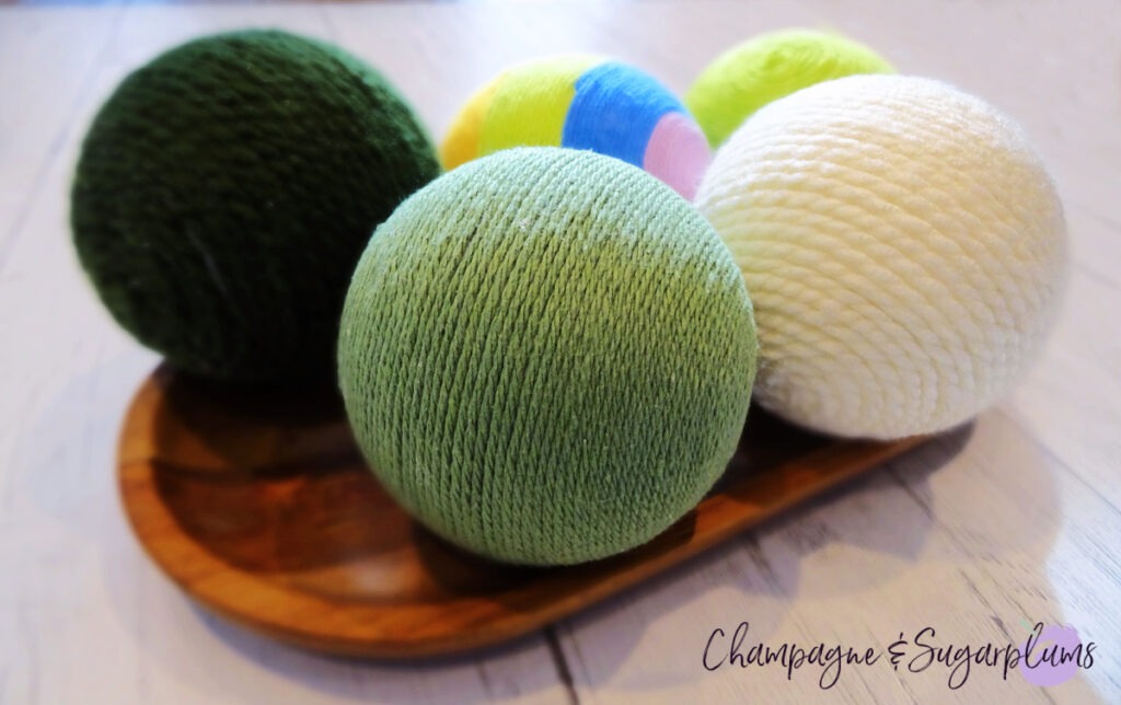 Lucky Green Balls - Styrofoam balls wrapped in varying shades of green on a white background by Champagne and Sugarplums