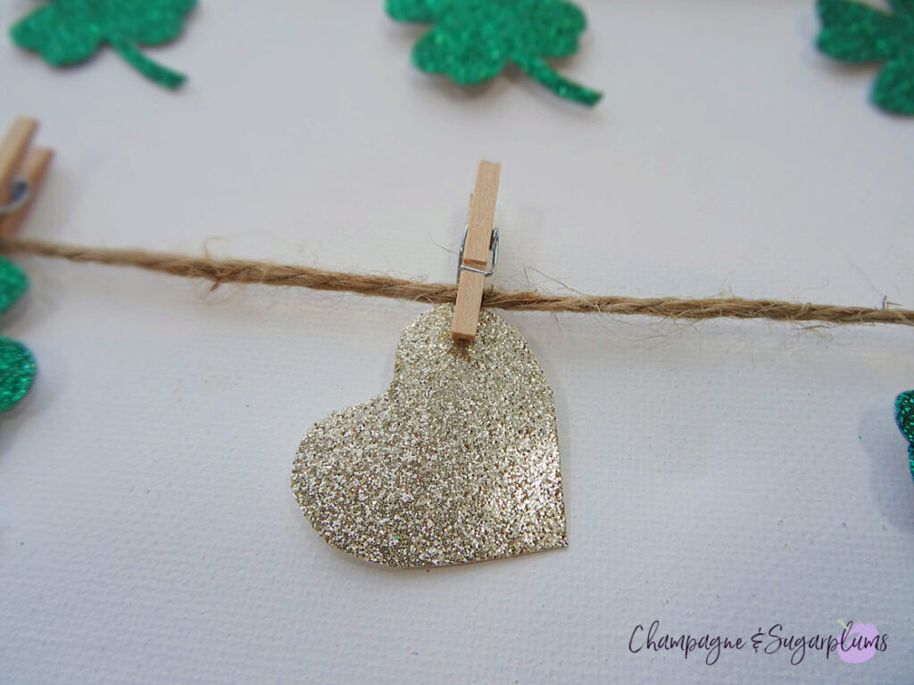 A close-up of a clover canvas, focusing on a gold heart by Champagne and Sugarplums