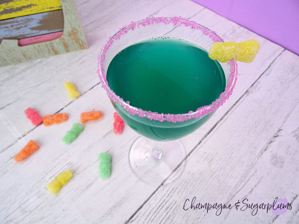 The tipsy bunny cocktail on a white background with sour candies by Champagne and Sugarplums