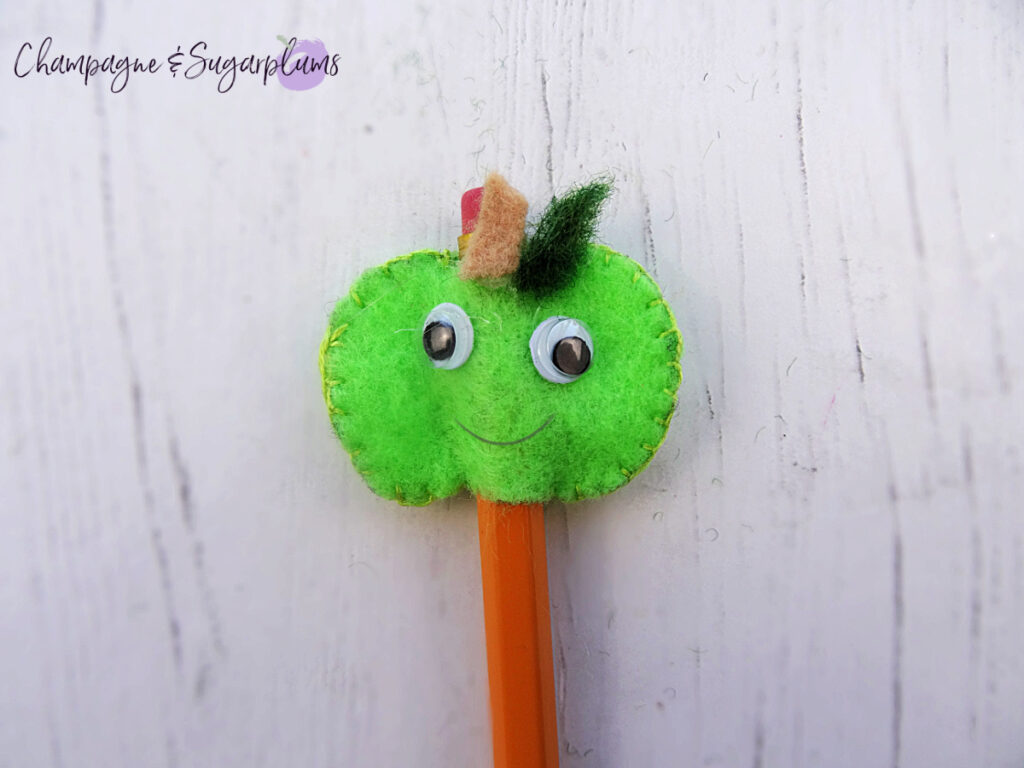 A felt green apple on a white background by Champagne and Sugarplums