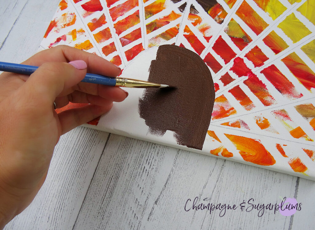 Painting a turkey head onto a canvas by Champagne and Sugarplums