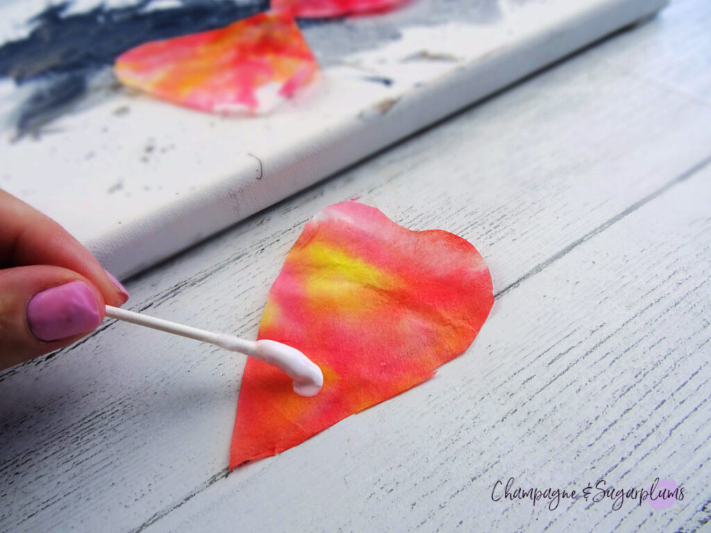 Putting glue onto coffee filter poppy petals by Champagne and Sugarplums