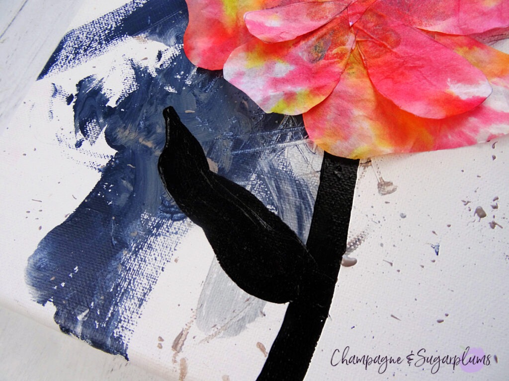 Panting a black stem and leaf onto a coffee filter poppy by Champagne and Sugarplums