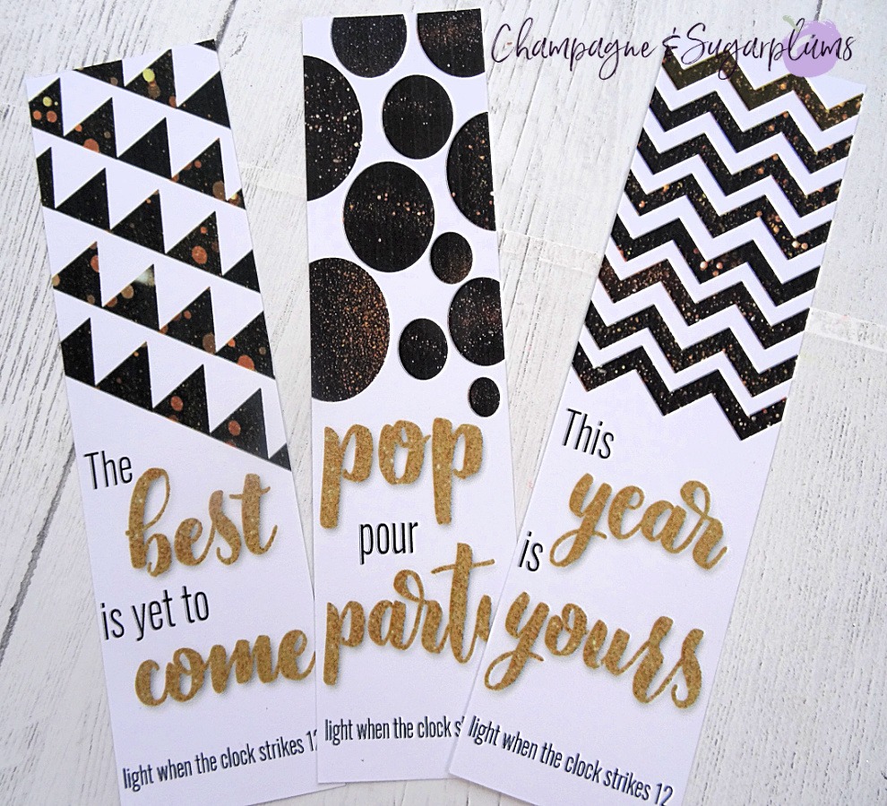 Three printed black and gold cards on a white background by Champagne and Sugarplums